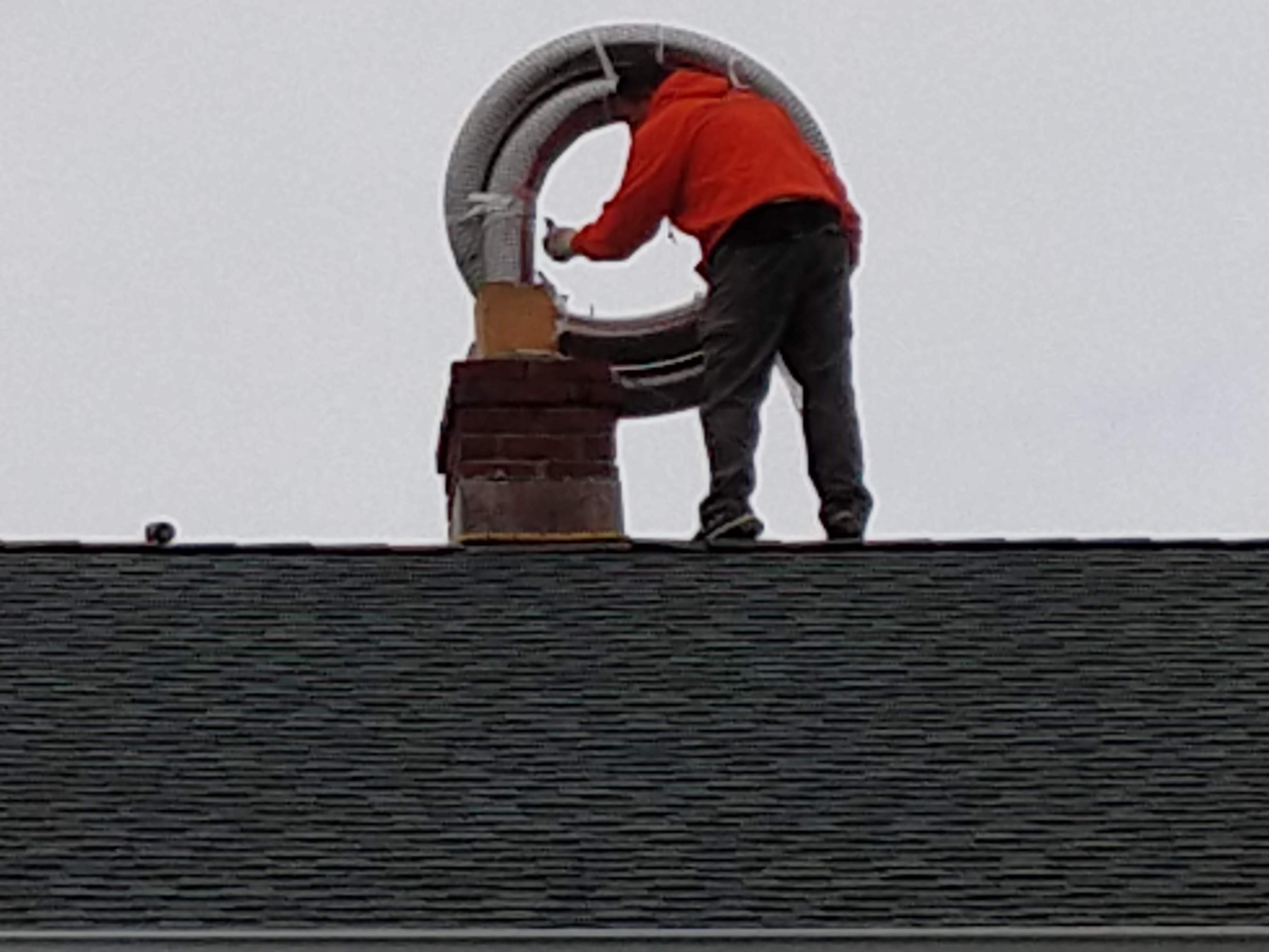 Flexible stainless chimney liner being installed in Bayville, New York